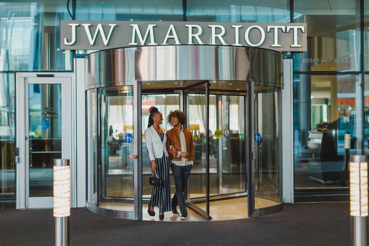 A couple exits the JW Marriot entrance